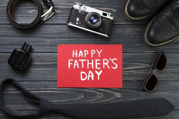 Father’s Day card with gifts on wood, highlighting men’s oral health at Sweet Smiles Orthodontics in Arlington, MA.