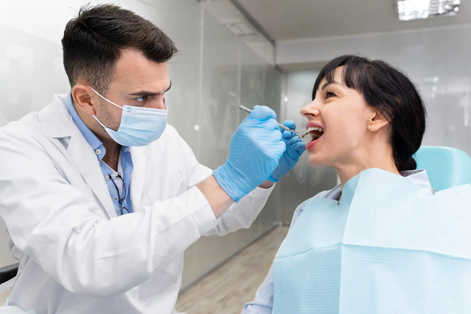A man and woman consult in a dental office at Sweet Smiles Orthodontics, discussing tongue thrust treatment in Arlington, MA