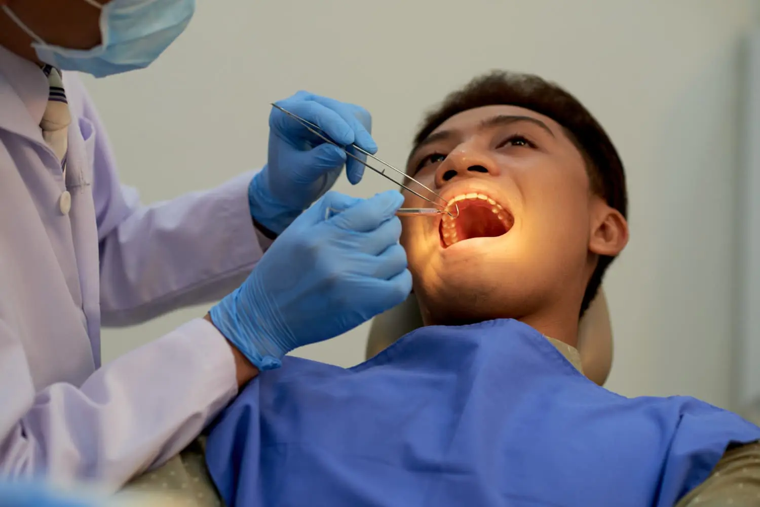A man receives a dental check-up for an underbite at Sweet Smiles Orthodontics in Arlington, MA