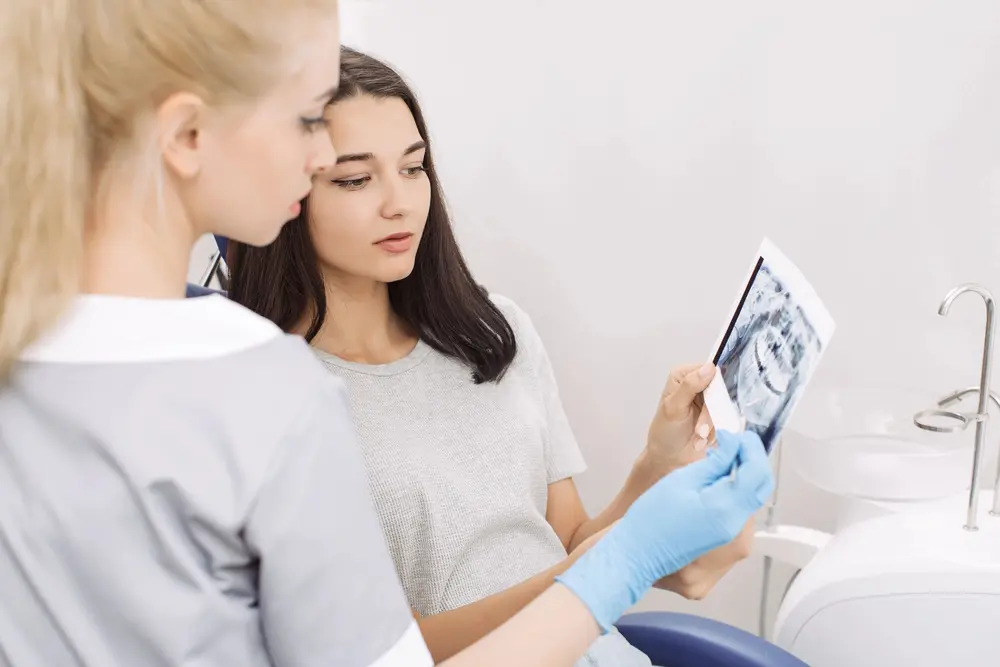 orthodontist showing x-ray image to patient - How to Fix Overbite in Arlington, MA.