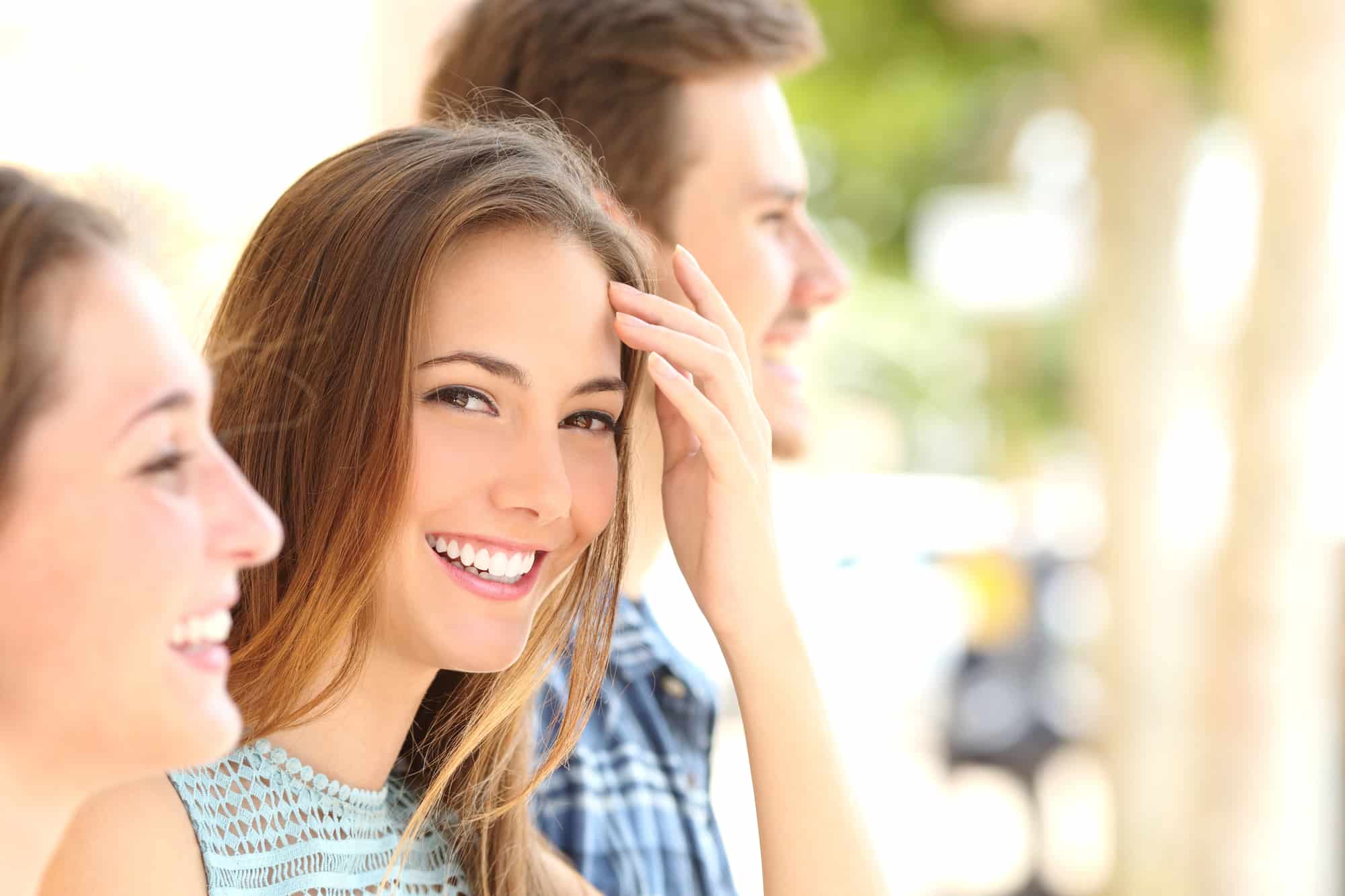 Happy young woman with beautiful straight smile showcasing successful Herbst appliance treatment results at Sweet Smiles Orthodontics in Arlington, MA